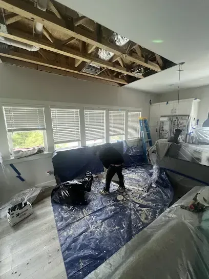 Ceiling opened up and the furniture covered while the room below dries out
