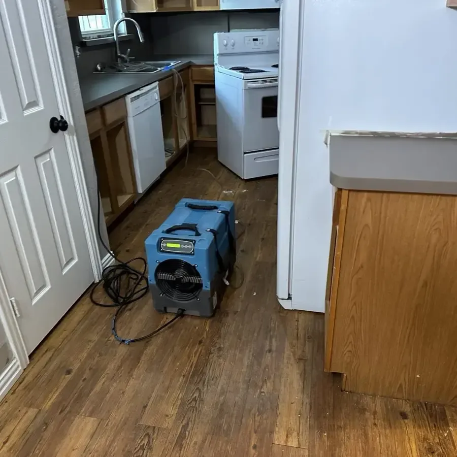 Water running across a floor from a leaking household appliance